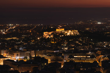 Fototapeta na wymiar Acropolis in Athens (Greece) at sunset. City landscape. City Lights