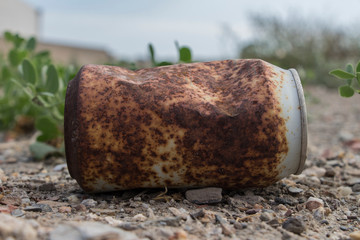 rusty soda can, rusty soda can lying in the field, rusty can, old rusty can outdoor,trash