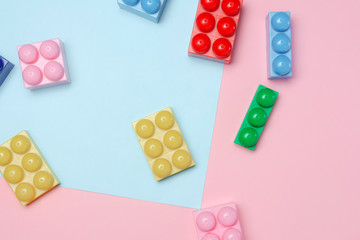 Flat lay of toy bricks on colored background. Educational concept