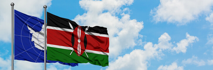 Antarctica and Kenya flag waving in the wind against white cloudy blue sky together. Diplomacy concept, international relations.
