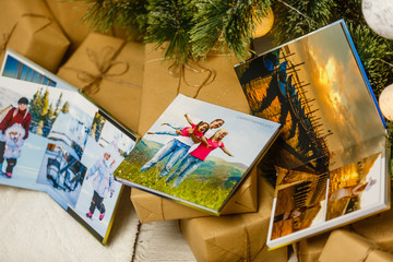 book together near Christmas tree in front of fireplace
