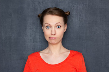 Portrait of surprised perplexed woman looking like stupid user