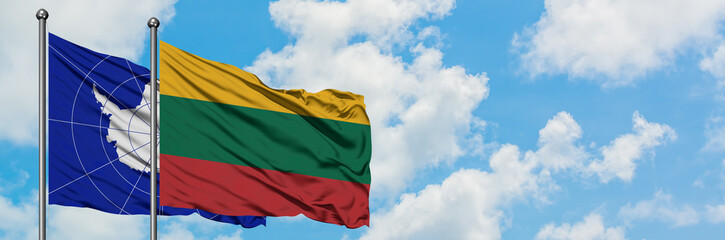 Antarctica and Lithuania flag waving in the wind against white cloudy blue sky together. Diplomacy concept, international relations.