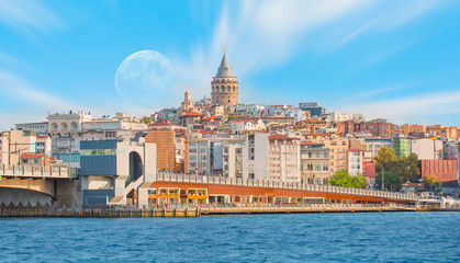 Galata Tower, Galata Bridge, Karakoy district and Golden Horn with full moon - Istanbul, Turkey