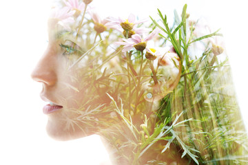 Double exposure of a young, happy woman’s profile combined with beautiful delicate pink flowers