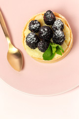 homemade Tart (tartlet) with blackberry and delicate cream of vanilla and mint