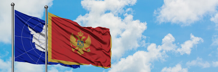 Fototapeta premium Antarctica and Montenegro flag waving in the wind against white cloudy blue sky together. Diplomacy concept, international relations.