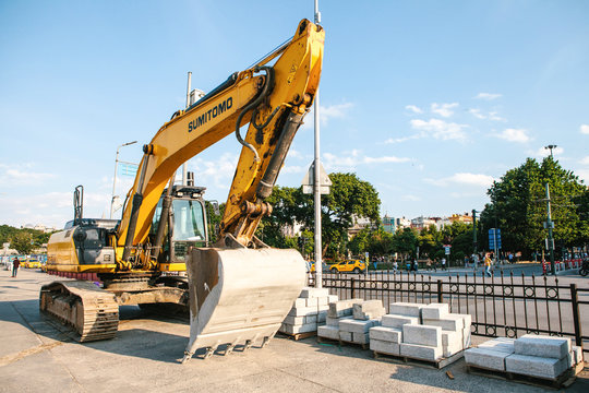 Istanbul, June 15, 2017: Yellow industrial Sumitomo excavator. Repair street works in the European part of the city near the port of Eminonu.