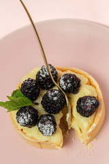 homemade Tart (tartlet) with blackberry and delicate cream of vanilla and mint