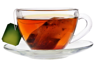 Glass cup with a bag of black tea isolated