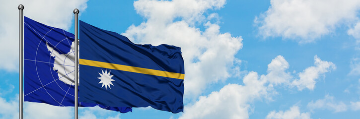 Antarctica and Nauru flag waving in the wind against white cloudy blue sky together. Diplomacy...