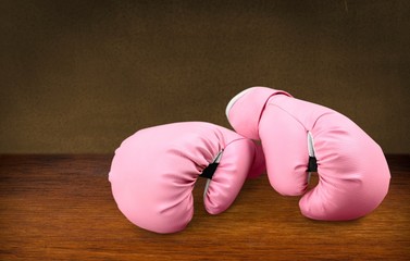 Pink boxing gloves on background