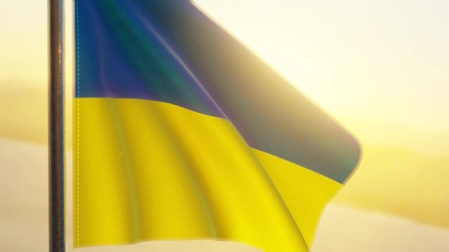 The Ukrainian flag waving in the wind at sunse