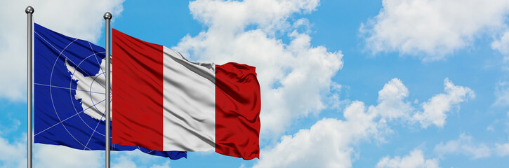 Antarctica and Peru flag waving in the wind against white cloudy blue sky together. Diplomacy concept, international relations.
