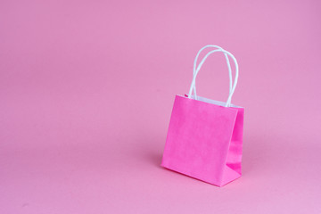 Paper shopping or gift bags  on pink background with copy spaсe. Concept sales, shopping, black friday. Giving gift for birthday, christmas and New Year. 