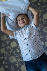 6 years old boy playing pillow fight game