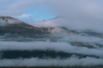 Naklejka premium Misty morning with fog around mountains and valley