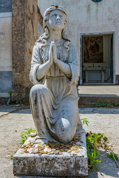 statue of an angel with coins