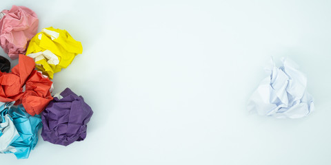 Crumpled  colorful paper is mauled on white blackground with copy space. ideas concept