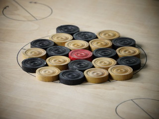 Side view of wooden carrom board game coins arranged for playing match. Concept of teamwork,...