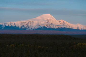 Alaskan mountains with glaciers and snow caps in autumn season during sunset