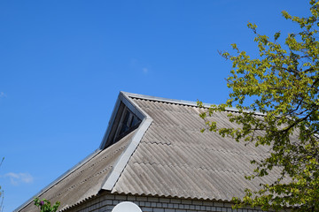 Old slate on the roof. The roof of the house is made of slate.