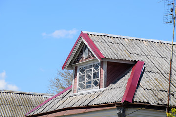 Old slate on the roof. The roof of the house is made of slate.