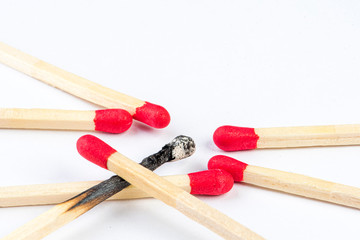 burned match with other matches with red head