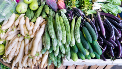 Various vegetables on the counter. organic fresh fruits and vegetables on grocery counter. Selling vegetables in Asia.