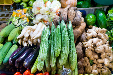 Various vegetables on the counter. organic fresh fruits and vegetables on grocery counter. Selling vegetables in Asia.
