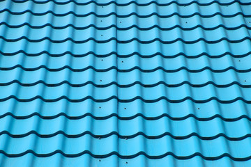 Turquoise metal tiles on roof of the house. Modern roofing materials