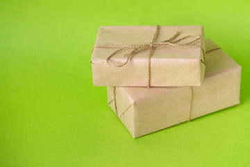 kraft paper gift box with on a green background. Christmas, New Year, Birthday and other holidays with gifts. Empty space for text
