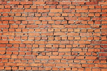 Fragment of textured red brickwork