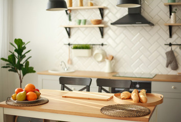 Background of modern kitchen interior with food fruits products on wooden table