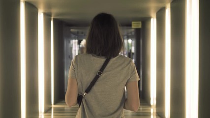 Travel woman using smartphone audio message voice recognition airport. Young Caucasian traveler checking boarding time with mobile phone app in terminal or train station.
