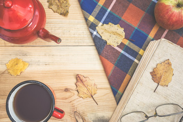 Autumn background with hot tea and book