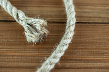 cut end of rope on wooden background