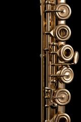 A part of a gold plated flute on a black background. An instrument common in the symphony orchestra © Janisphoto