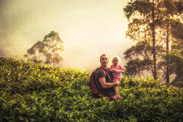 Naklejka na ściany i meble Happy father explorer with child daughter among tropical thickets in the mountains during vacation looking at beautiful scenery as family travelling lifestyle 