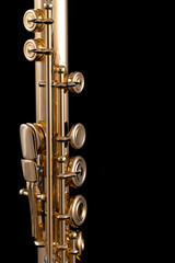 A part of a gold plated flute on a black background. An instrument common in the symphony orchestra