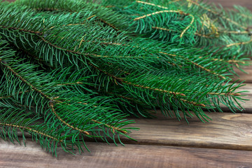 spruce branches on a wooden surface