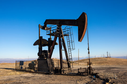 View of Oil Well Pumpjack (Horsehead) at Daylight Oil Industry