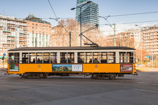 Yellow tram with passengers in Milano