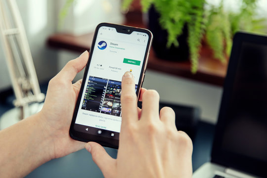 WROCLAW, POLAND - JULY 31th, 2019: Woman installs Netflix application on the Xiaomi A2 smartphone. Steam is a video game digital distribution platform developed by Valve Corporation