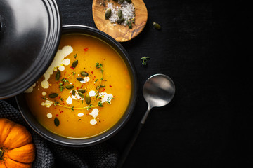 Creamy pumpkin soup served in bowl