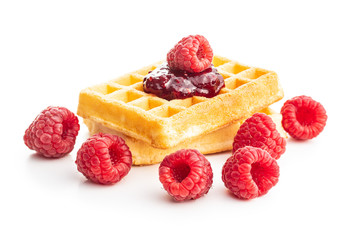 Tasty sweet waffles with raspberries and jam.