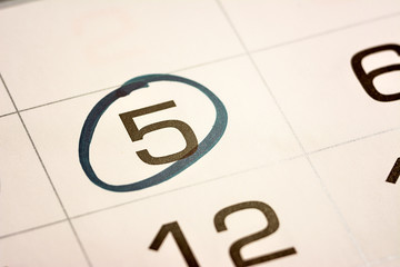 the fifth day of the month highlighted on the calendar with a frame close-up macro, the mark on the calendar, the fifth date