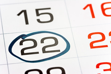 twenty-second day of the month highlighted on the calendar with a frame close-up macro, mark on the calendar, twenty-second date