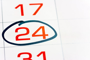 twenty-fourth of the month highlighted on the calendar with a frame close-up macro, mark on the...