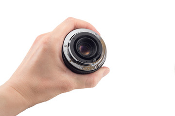 view of the back lens of the detachable camera lens in hand, the back of the lens, mount to the camera, isolated on white background